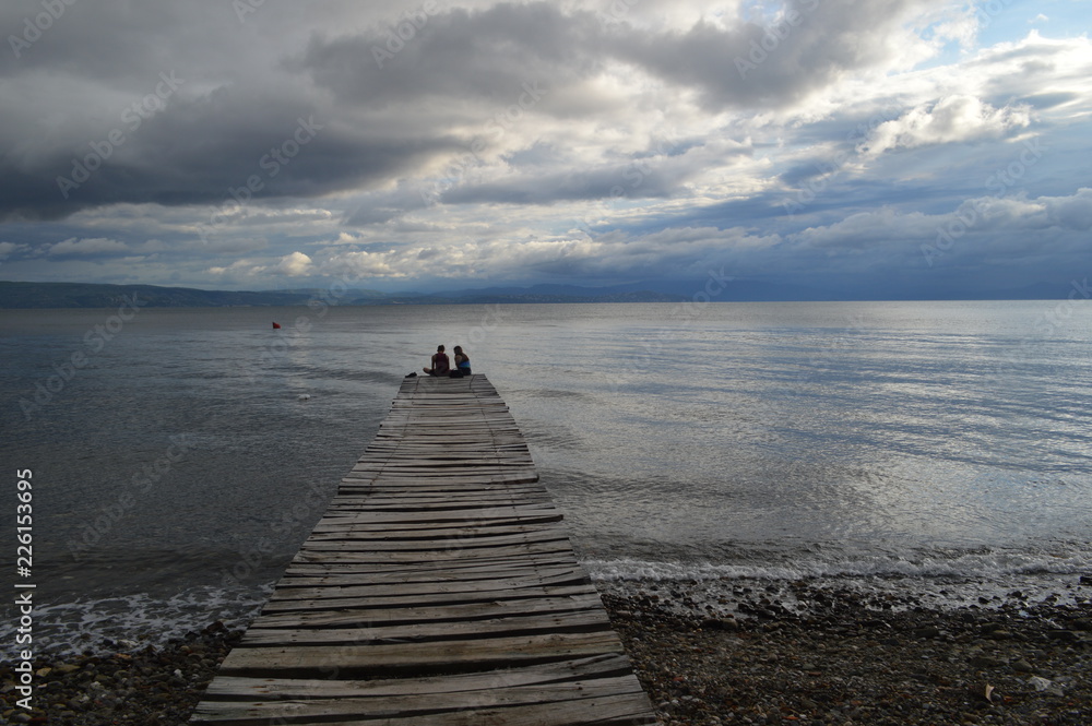 Fototapeta premium Landscape afternoon Beach with Jetty and Couple in Love