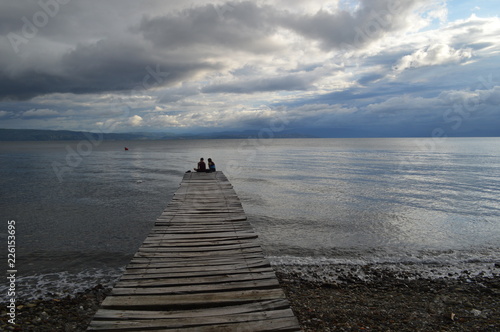 Landscape afternoon Beach with Jetty and Couple in Love