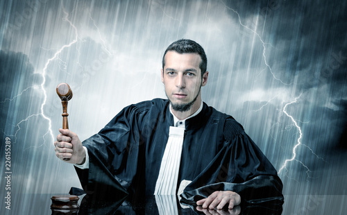 Young handsome judge with stormy wallpaper  photo