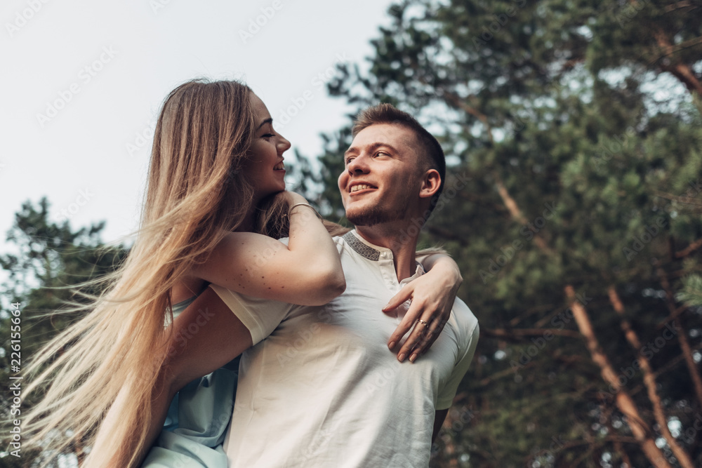 Fototapeta premium Beautiful Young Couple Have Fun at Sunset Outside of City