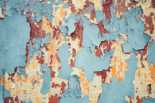 Wall texture with peeling paint of several colors