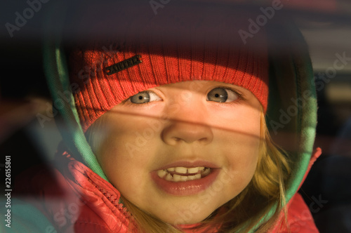 little girl looks out of the car
