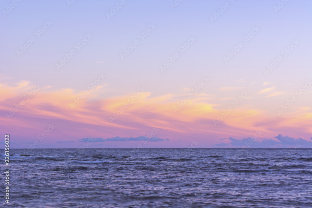 Ocean and sky at sunset, horizon line. Minimalism in the landscape.