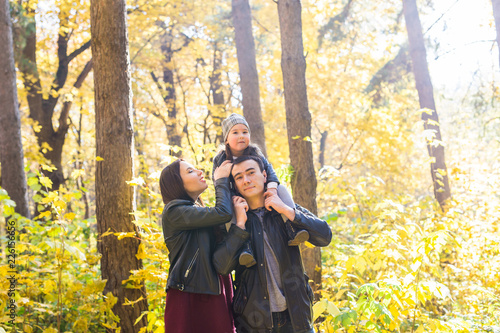 Fall, nature and family concept - happy family walking in autumn park © satura_