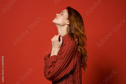 woman in sweater in profile is smiling