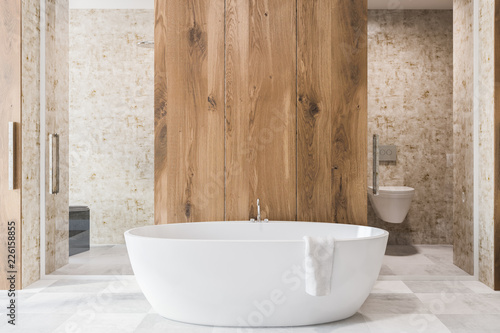 Wooden bathroom interior, white tub