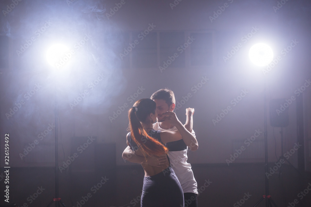 Active happy adults dancing bachata together in dance class