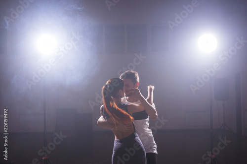 Active happy adults dancing bachata together in dance class