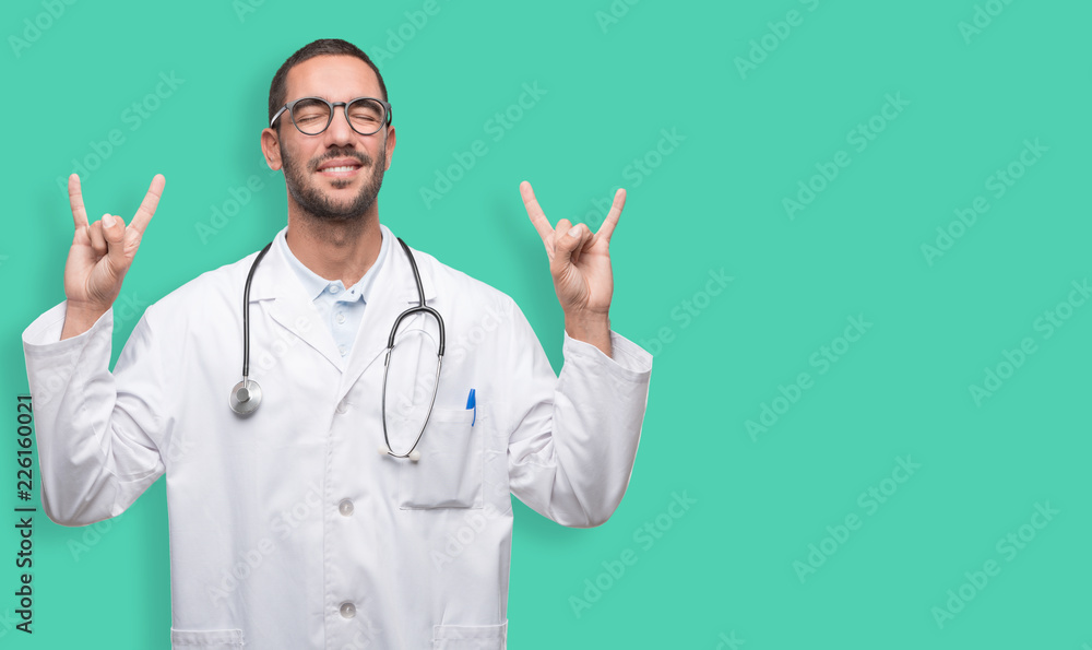Happy young doctor with a gesture of rock Happy young doctor with a gesture of rock