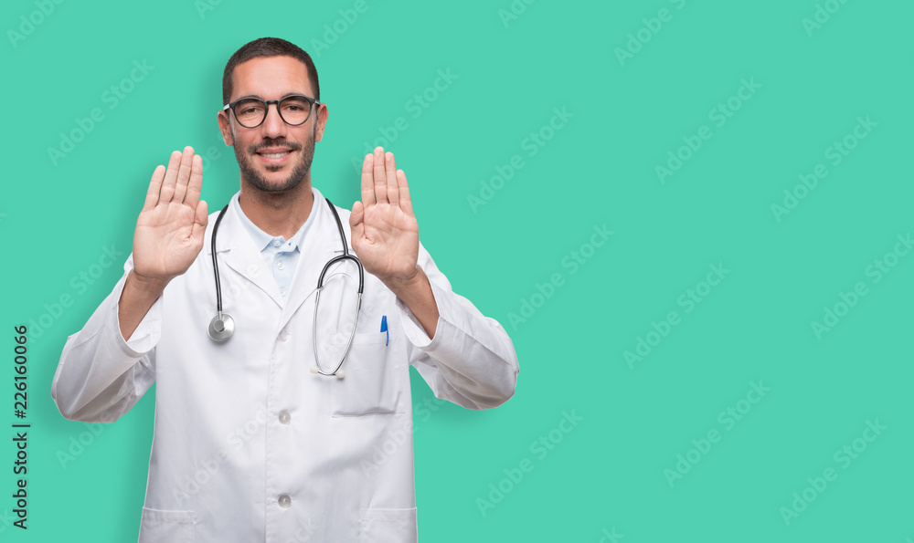 Young doctor doing a gesture of stop with his hands Young doctor doing a gesture of stop with his hands