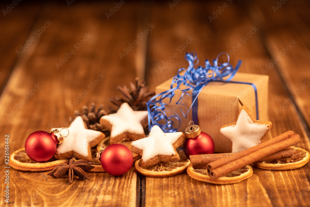 present, cinnamon stars and christmas balls on wooden background present, cinnamon stars and christmas balls on wooden background