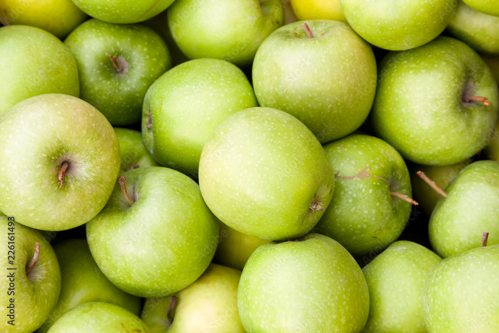 A lot of green apples as a background A lot of green apples as a background
