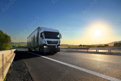 Truck transport on the road at sunset 