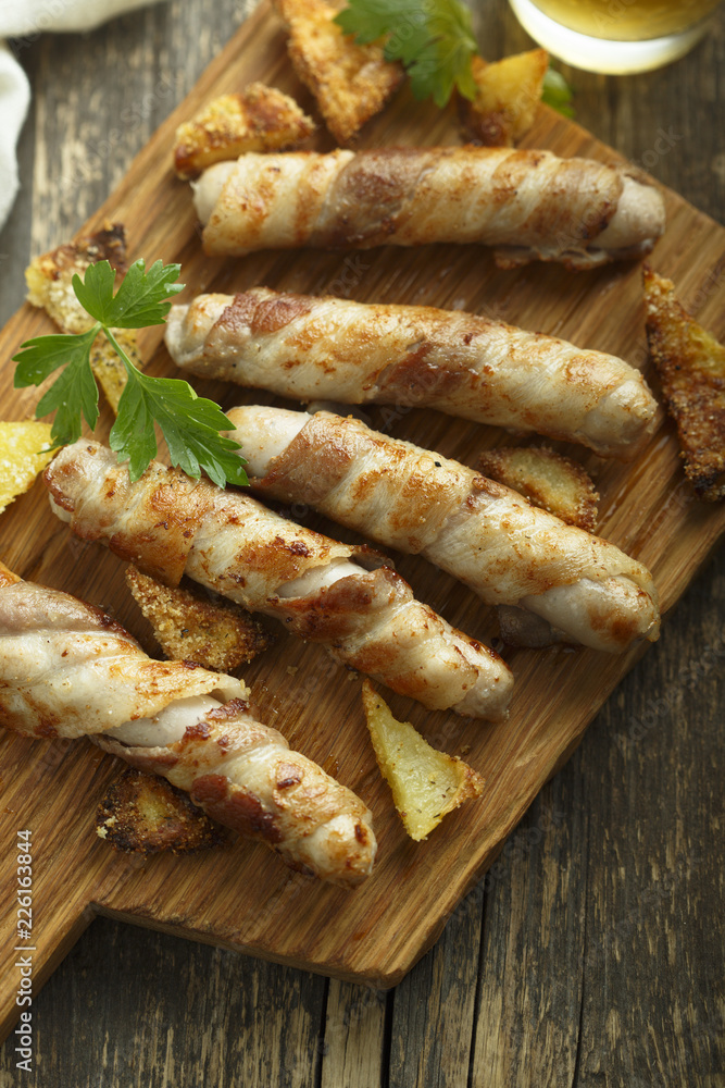 Grilled sausages wrapped with bacon Grilled sausages wrapped with bacon