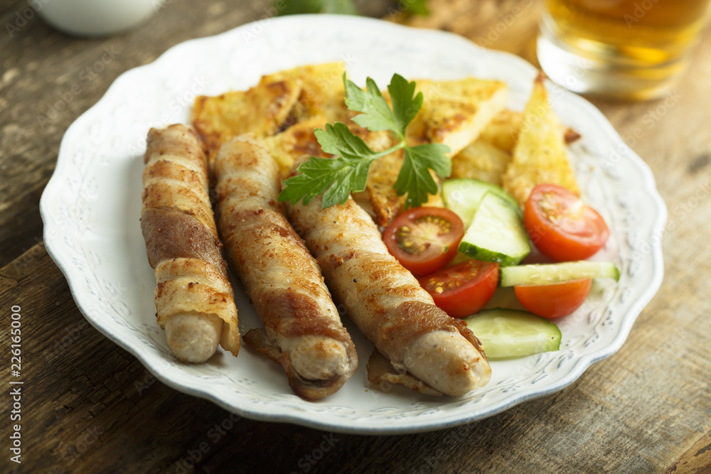 Grilled sausages wrapped with bacon Grilled sausages wrapped with bacon