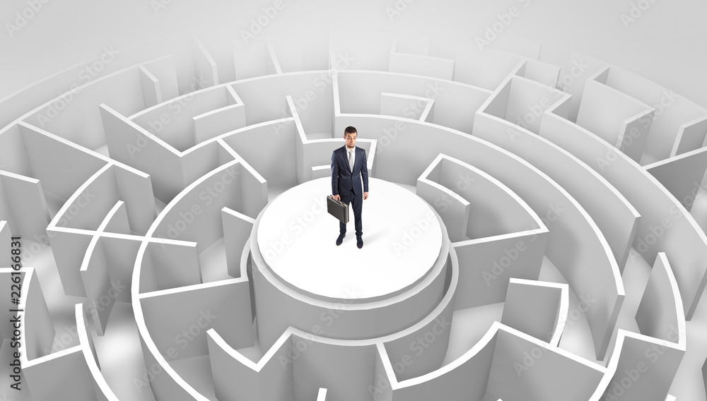 Businessman standing on the top a maze and looking through
Businessman standing on the top a maze and looking through