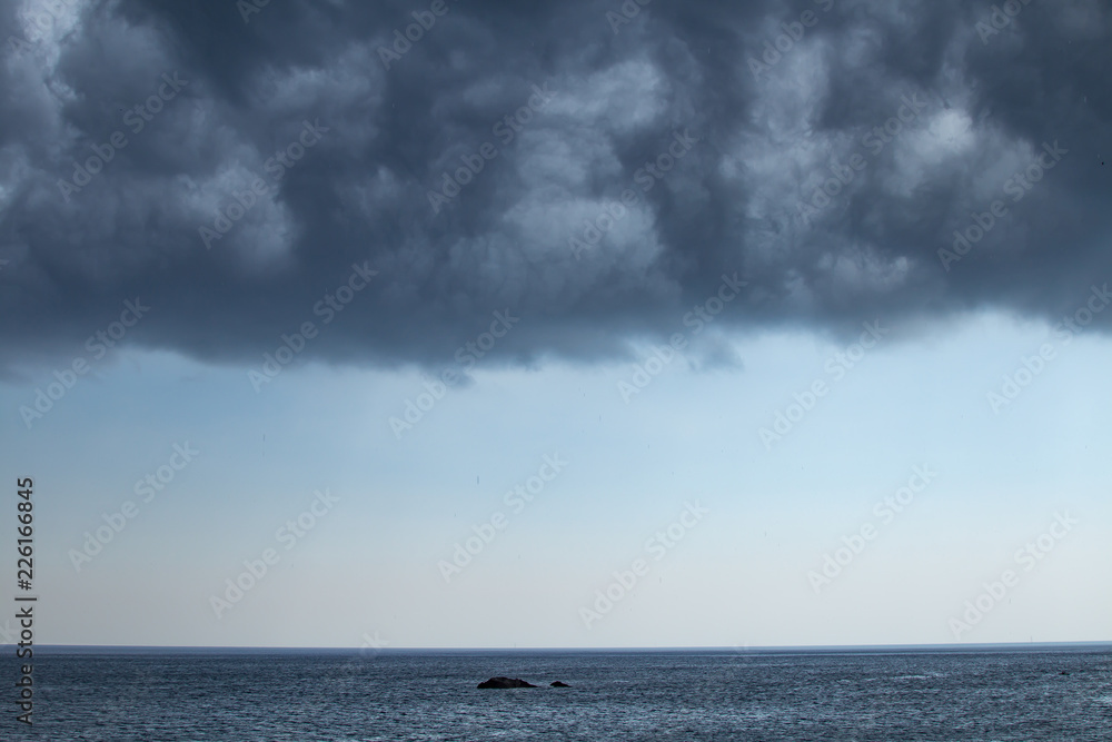 Dark moody sky over the gray sea