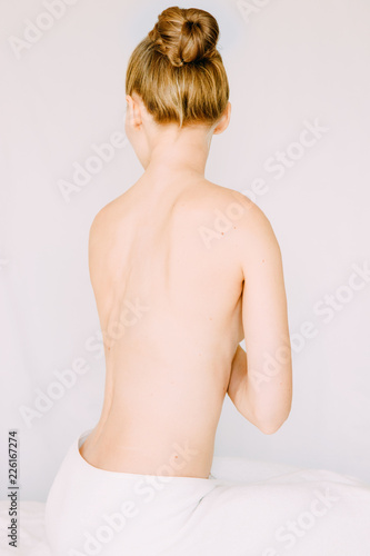 Back view of Woman wearing towel  prepare her body for shower  spa or massage