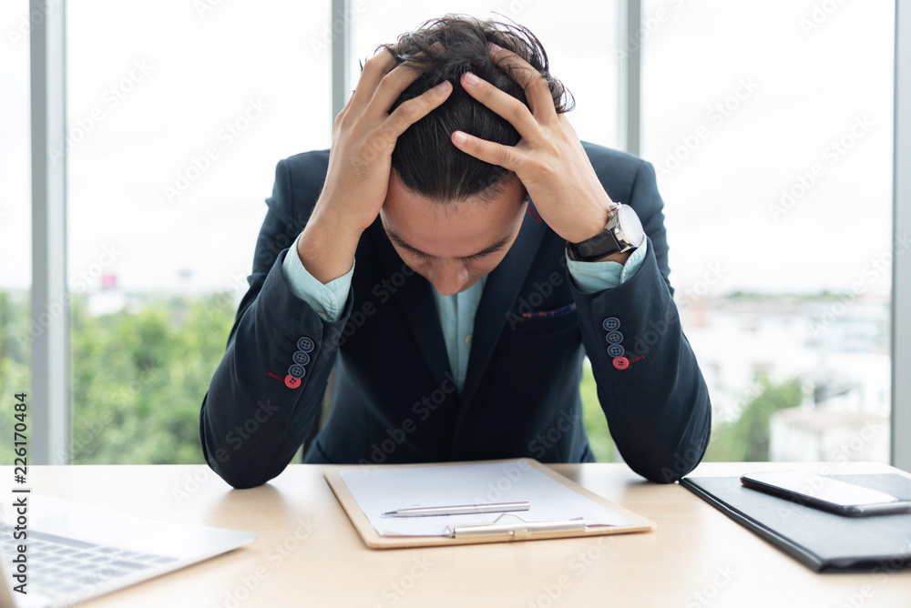 Stressed Businessman is holding his head with his hands. Stressed Businessman is holding his head with his hands.