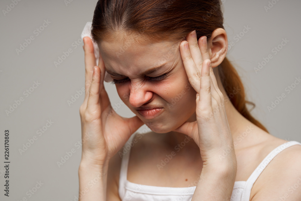 woman holding her head headache runny nose sore throat flu woman holding her head headache runny nose sore throat flu