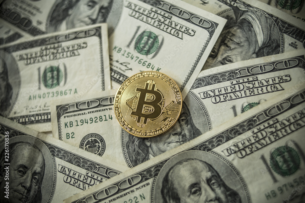 Golden Bitcoins Coins lying on dollars. Golden Bitcoins Coins lying on dollars.