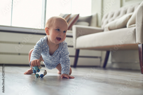 little baby boy crawling on floor at home photo