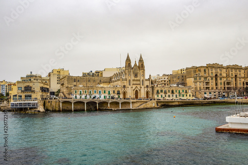 St. Julian's urban skyline at Balluta Bay, Malta under dark moody March sky