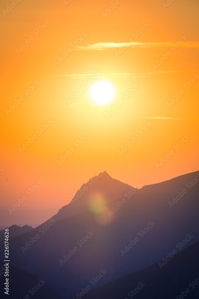 A beautiful, colorful, abstract mountain scenery in sunrise. Minimalist landscape of mountains in morning in blue tones. Tatra mounains in Slovakia, Europe.