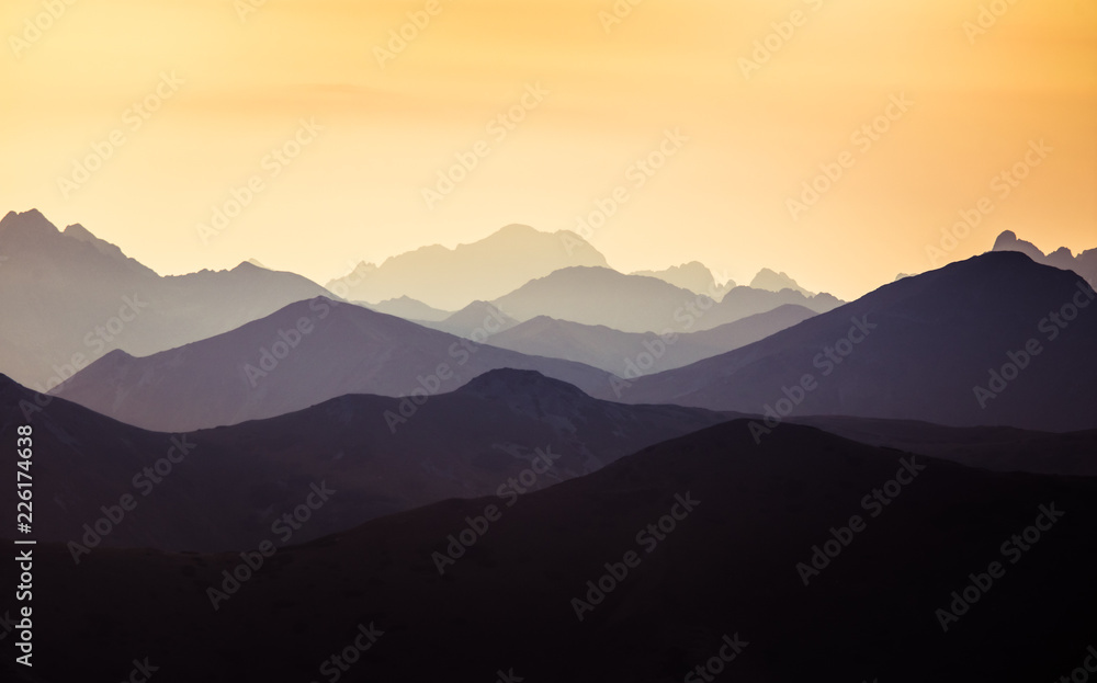 A beautiful, colorful, abstract mountain scenery in sunrise. Minimalist landscape of mountains in morning in blue tones. Tatra mounains in Slovakia, Europe.