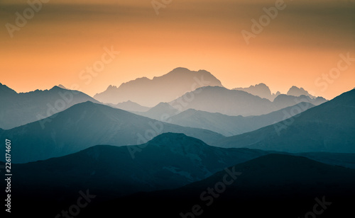 A beautiful  colorful  abstract mountain scenery in sunrise. Minimalist landscape of mountains in morning in blue tones. Tatra mounains in Slovakia  Europe.