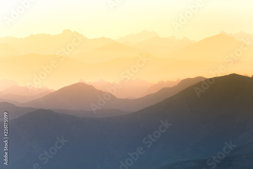 Colorful, abstract double exposure of mountains in sunrise. Minimalist scenery with color gradients. Tatra mountains in Slovakia, Europe. © dachux21