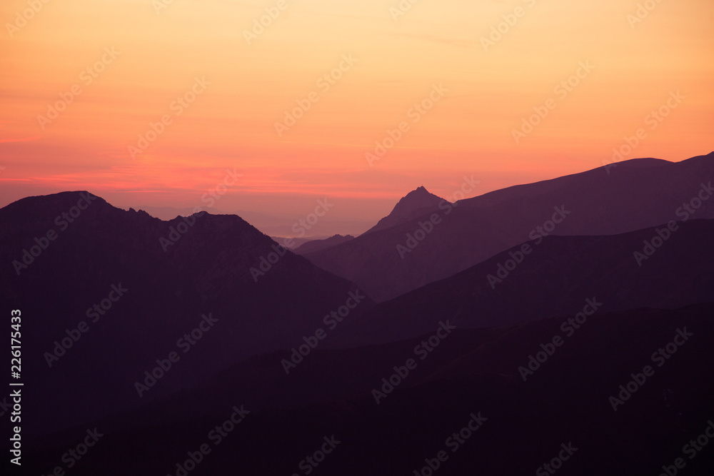 A beautiful, colorful sunrise sceney in mountains in purlpe tone. Abstract, minimalist landscape in Tatra mountains. Color gradients. Tatra mountains in Slovakia, Europe.