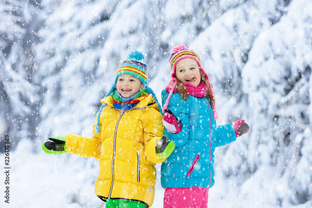 Child playing with snow in winter. Kids outdoors. Child playing with snow in winter. Kids outdoors.