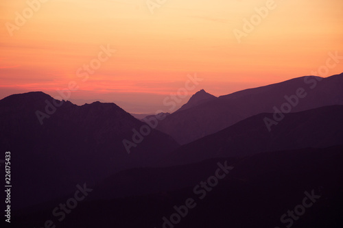 A beautiful  colorful sunrise sceney in mountains in purlpe tone. Abstract  minimalist landscape in Tatra mountains. Color gradients. Tatra mountains in Slovakia  Europe.