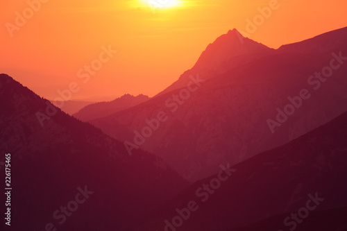 A beautiful  colorful sunrise sceney in mountains in purlpe tone. Abstract  minimalist landscape in Tatra mountains. Color gradients. Tatra mountains in Slovakia  Europe.