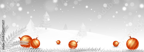 Winter landscape background with snow covered Xmas trees and baubles for Christmas festival celebration. Website header or banner.