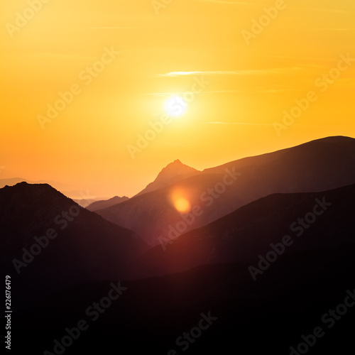 A beautiful minimalist landscape during the sunrise over mountains in warm tones. Abstract  colorful scenery of mountains in morning. Tatra mountains in Slovakia  Europe.