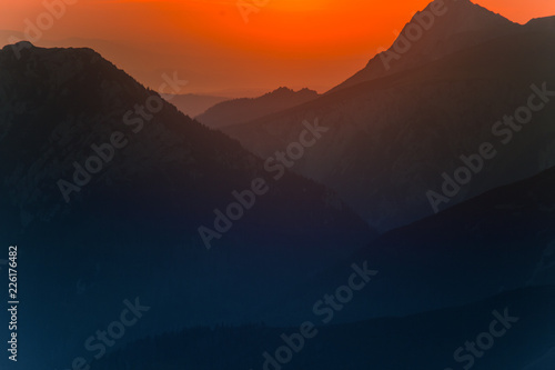 A beautiful minimalist landscape during the sunrise over mountains in warm tones. Abstract  colorful scenery of mountains in morning. Tatra mountains in Slovakia  Europe.