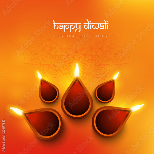 Top view of illuminated earthen lamp on glossy orange background for Happy Diwali celebration. Can be used as greeting card design.