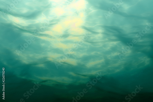 Marine underwater scene. Sea water surface, bottom view.