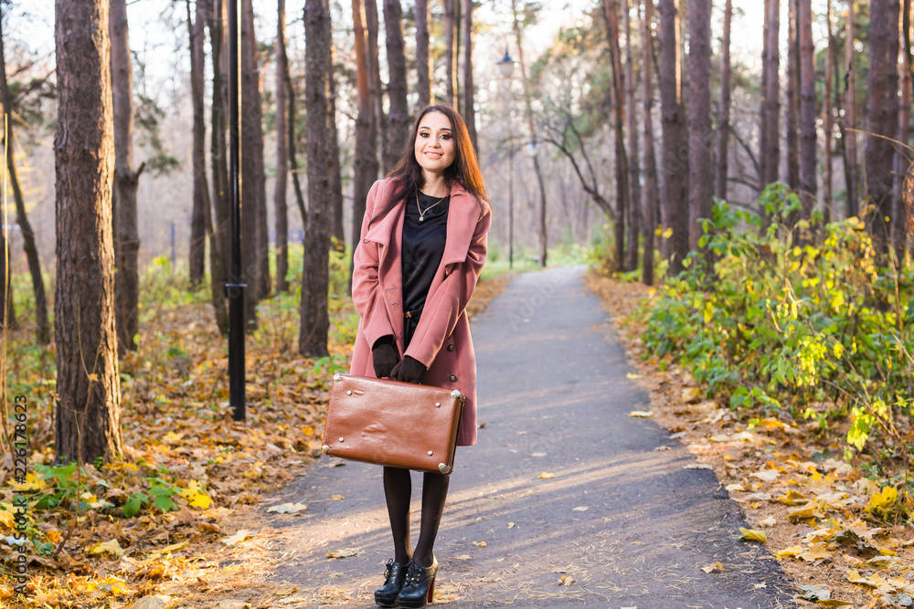 Autumn, nature and people concept - Young beautiful woman in grey coat in fall nature - obrazy, fototapety, plakaty 