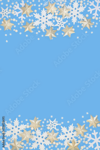 Fototapeta Naklejka Na Ścianę i Meble -  Snowflake and star christmas abstract background border on blue. Festive card for the Christmas holiday and winter season with copy space.
