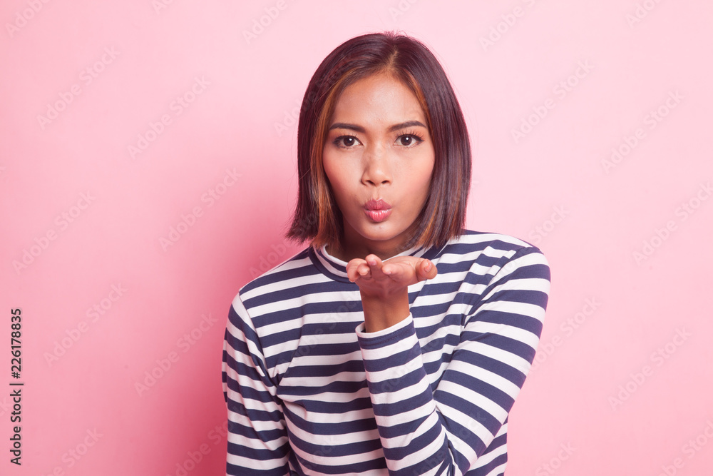 Beautiful young Asian woman blow a kiss. Beautiful young Asian woman blow a kiss.