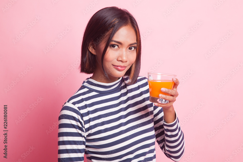 Young Asian woman drink orange juice. Young Asian woman drink orange juice.