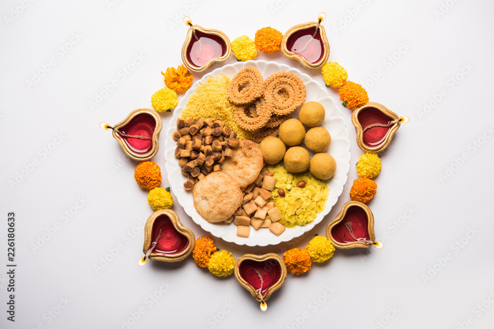 Snack Rangoli Diwali Rangoli or design made using Indian snacks/sweet and diya or ...