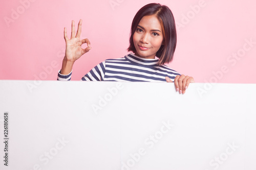 Young Asian woman show OK with blank sign.