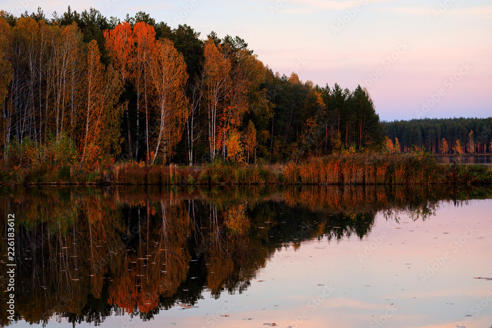 Autumn landscape of the Ural.Russia. Beautiful autumn trees by the lake