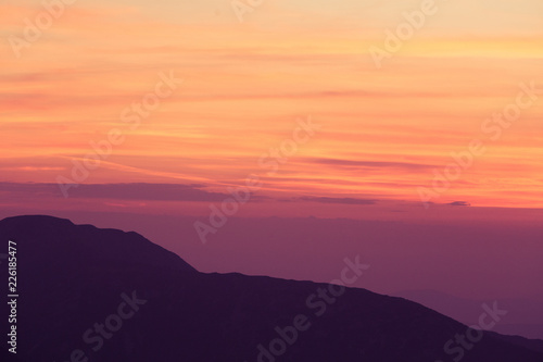 A beautiful, minimalist scenery of mountain sunset in purple tones. Abstract, colorful mountain landscape. Tatra mountains in Slovakia, Europe.