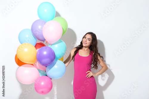 Young girl with colored balloons on white background © 5second