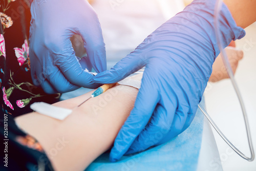 Medical drip tubing and patient at the hospital. photo